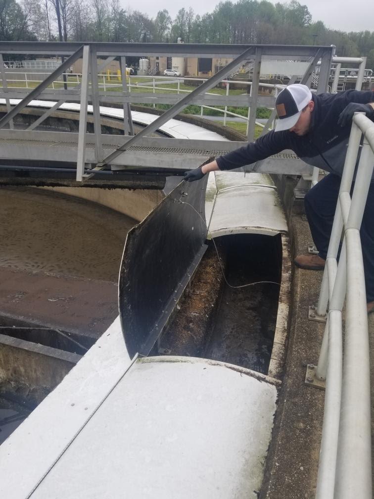 Dane Walls, a Bureau of Utility Operations technician inspects a secondary clarifier weir at the Maryland City Water Reclamation Facillity in Maryland City.