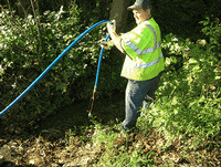 Person cleaning drain pipe