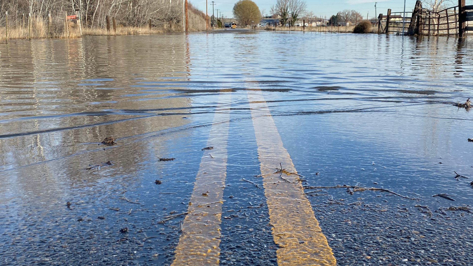 flooded roadway with double yellow lines