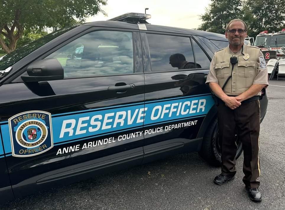 Reserve Officer standing next to  vehicle